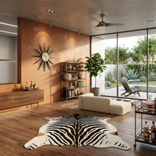 Load image into Gallery viewer, Large faux zebra print rug in a modern living room with wood floors and natural light