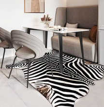 Load image into Gallery viewer, Zebra print artificial cowhide rug in modern dining room with gray chairs and bench seating