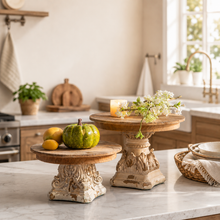 Load image into Gallery viewer, Set of 2 rustic French Provincial wooden pedestal stands on a marble counter with decor.