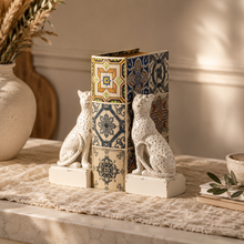 Load image into Gallery viewer, Maison Leopard Bookends in rustic white resin holding patterned books on a textured tablecloth.