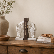 Load image into Gallery viewer, Rustic white horse head bookends by Decor Home holding a book on a wooden dresser.
