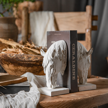 Load image into Gallery viewer, Set of 2 rustic white horse head bookends by Decor Home holding a book on a wooden table.
