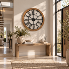 Load image into Gallery viewer, Hampton Grove wood and rattan wall clock with black Roman numerals above a rustic console table
