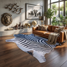 Load image into Gallery viewer, Large faux zebra print rug in modern living room with leather sofa and safari decor accents
