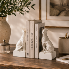 Load image into Gallery viewer, Maison Leopard Bookends in rustic white resin holding a set of books on a wooden table.
